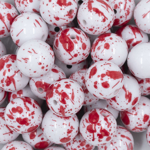Close up view of a pile of 20mm Red Splatter [NO AB] Chunky Acrylic Bubblegum Beads