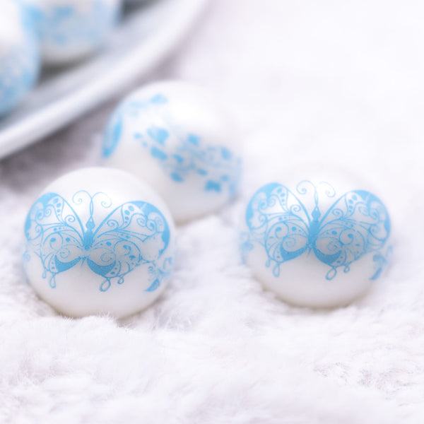 Macro view of 20mm Blue Butterfly pattern on white matte chunky acrylic Bubblegum Beads