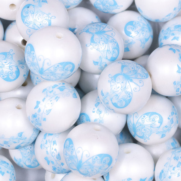 Close up view of a pile of 20mm Blue Butterfly pattern on white matte chunky acrylic Bubblegum Beads