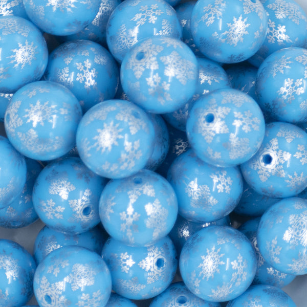 Close up view of a pile of 20mm Silver Snowflake Print on Blue Acrylic Bubblegum Beads