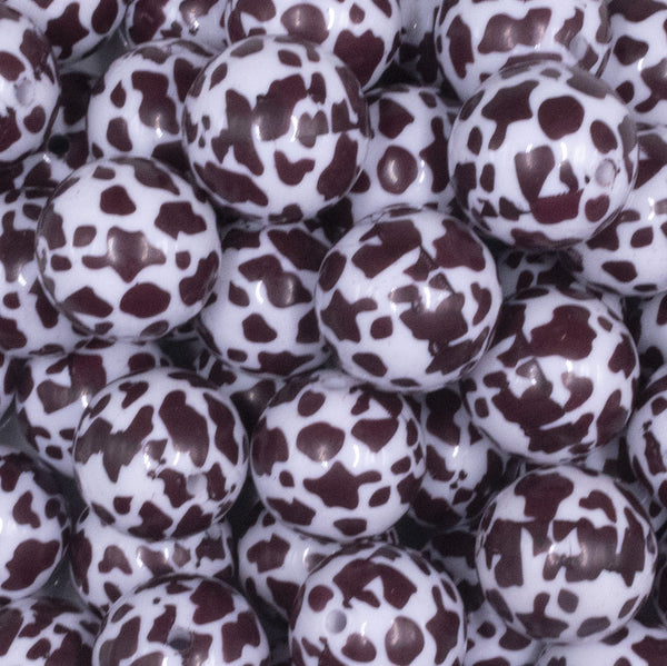 close up view of a pile of 20mm White and Brown Cow Print Bubblegum Beads