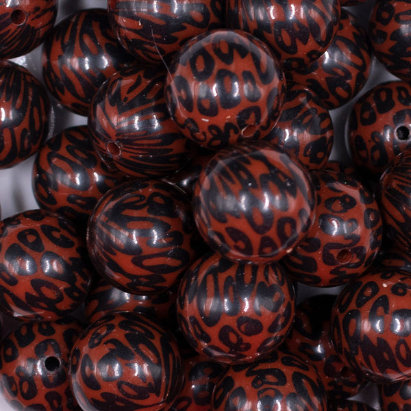 Close up view of a pile of 20mm Brown and Black Leopard Animal Print Acrylic Bubblegum Beads