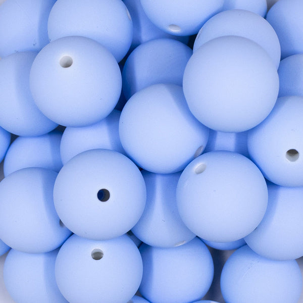 Close up view of a pile of 20mm Cornflower Blue Matte 