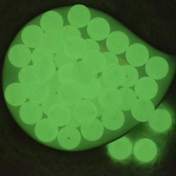 Top view of a glowing pile of 20mm Glow in the Dark Solid Bubblegum Beads