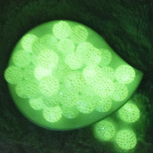 glowing view of a pile of 20mm Glow in the Dark Rhinestone AB Bubblegum Beads