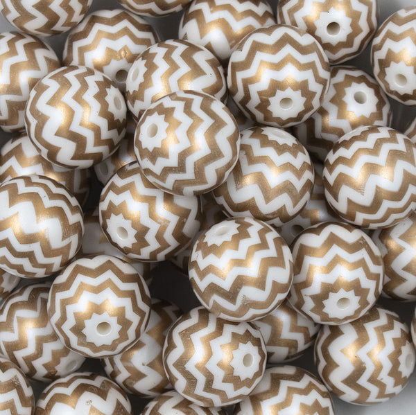 Close up view of a pile of 20mm Gold with Matte White Chevron Bubblegum Beads