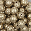 Close up view of a pile of 20mm Gold Polka Dots Bubblegum Beads