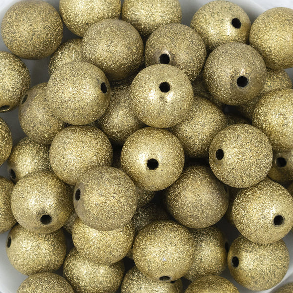 Close up view of a pile of 20mm Gold Stardust Chunky Bubblegum Beads