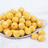 Front view of a pile of 20mm Golden Yellow with White Stars Bubblegum Beads