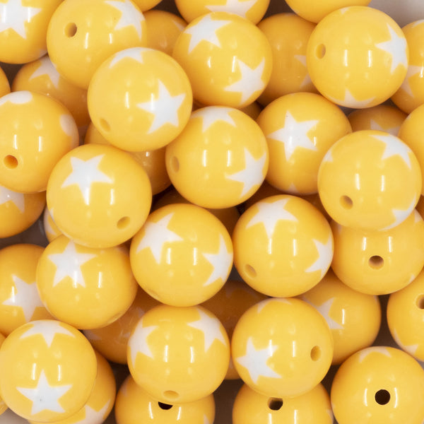 Close up view of a pile of 20mm Golden Yellow with White Stars Bubblegum Beads