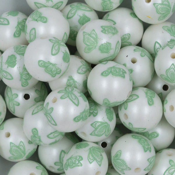 Close up view of a pile of 20mm Green Butterfly pattern chunky acrylic Bubblegum Beads