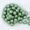 Top view of a pile of 20mm Green Pearl with Silver Snowflake Print Acrylic Bubblegum Beads