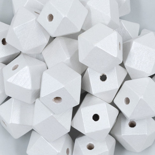 Close up view of a pile of 20mm White Painted Hexagon Wooden Beads