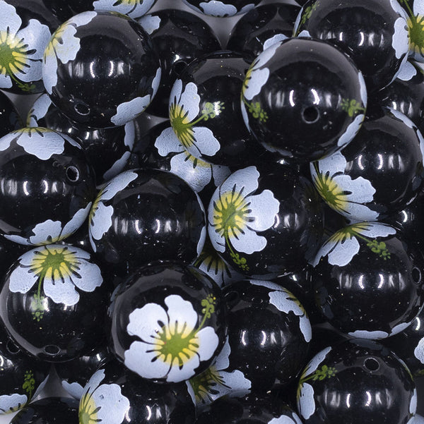 Close up view of a pile of 20mm Hibiscus flower print on Black Chunky Acrylic Bubblegum Beads [10 Count]