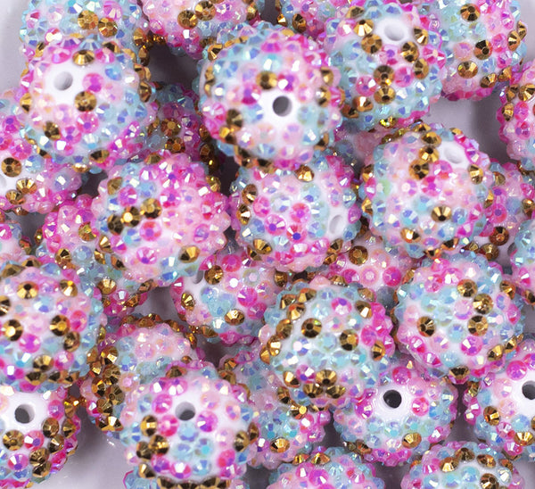 Close up view of a pile of 20mm Hot Pink, Blue, Gold Confetti Rhinestone AB Bubblegum Beads