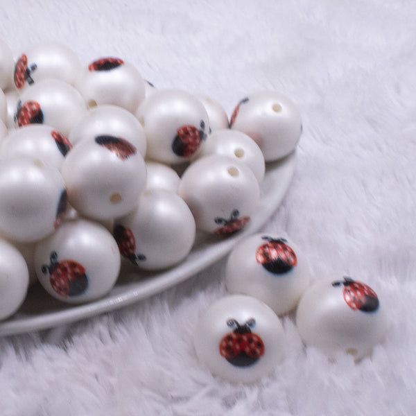 front view of a pile of 20mm Ladybug print on Matte White Acrylic Bubblegum Beads