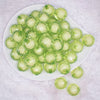 top view of a pile of 20mm Lime Green Translucent Faceted Bead in a bead Bubblegum Bead