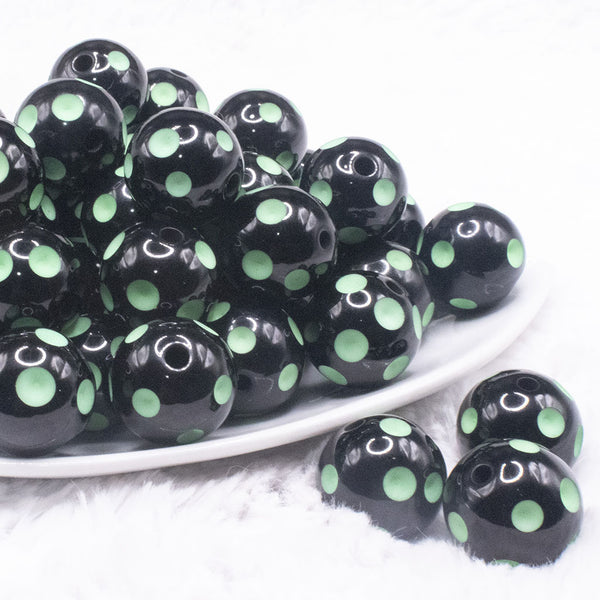 front view of a pile of 20mm Green Polka Dots on Black Bubblegum Beads