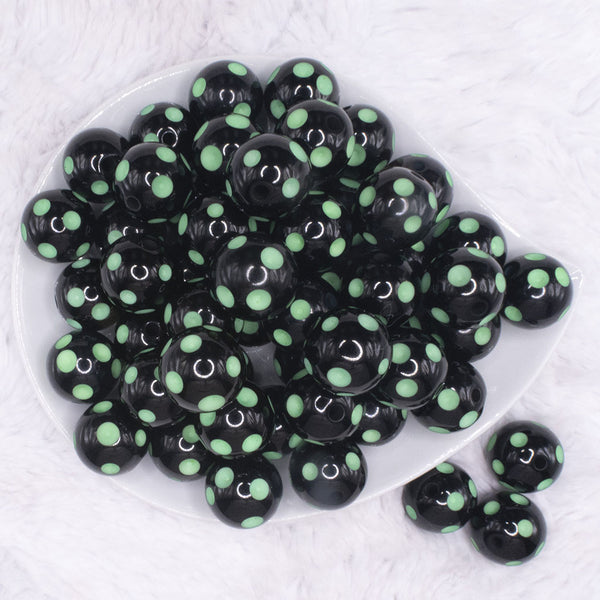 top view of a pile of 20mm Green Polka Dots on Black Bubblegum Beads