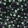 close up view of a pile of 20mm Green Polka Dots on Black Bubblegum Beads