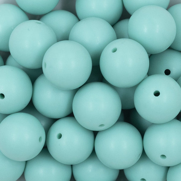Close up view of a pile of 20mm Aqua Blue Matte Solid Bubblegum Beads