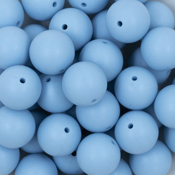 Close up view of a pile of 20mm Cornflower Blue Matte Solid Bubblegum Beads