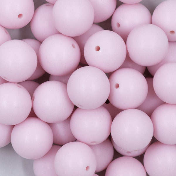 Close up view of a pile of 20mm Cotton Candy Pink Matte Solid Bubblegum Beads