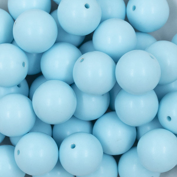 Close up view of a pile of 20mm Ice Blue Matte Solid Bubblegum Beads
