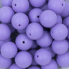 Close up view of a pile of 20mm Iris Purple Matte Solid Bubblegum Beads