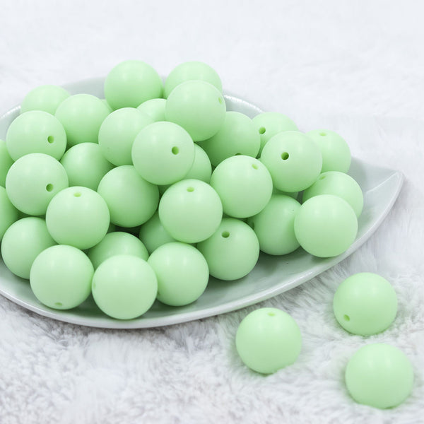 Front view of a pile of 20mm Mint Green Matte Solid Bubblegum Beads