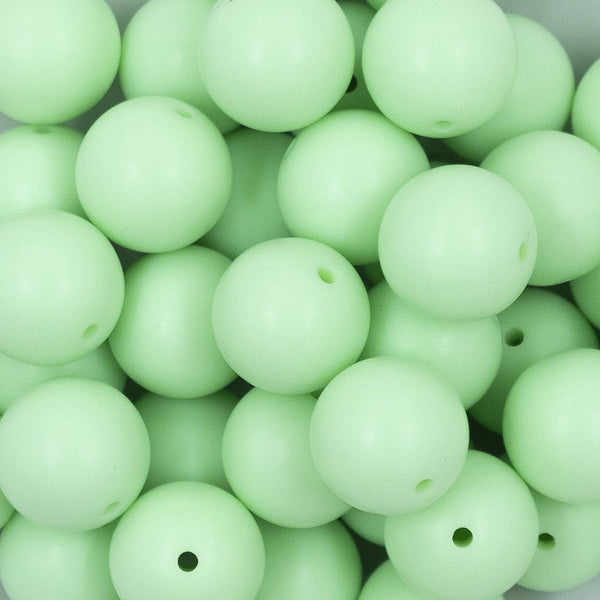 Close up view of a pile of 20mm Mint Green Matte Solid Bubblegum Beads