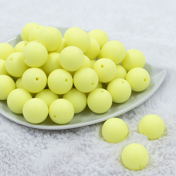 Front view of a pile of 20mm Yellow Matte Solid Bubblegum Beads