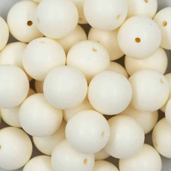 Close up view of a pile of 20mm Off White Matte Solid Bubblegum Beads
