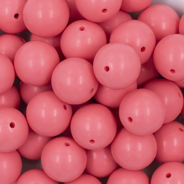 Close up view of a pile of 20mm Punch Pink Matte Solid Bubblegum Beads