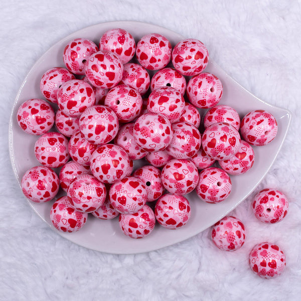Top view of a pile of 20mm Red Hearts on Pink opaque Acrylic Bubblegum Beads
