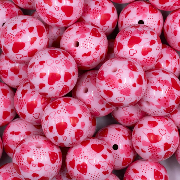 Close up view of a pile of 20mm Red Hearts on Pink opaque Acrylic Bubblegum Beads