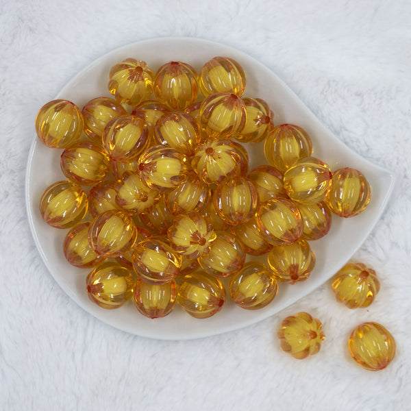 Top view of a pile of 20mm Mustard Yellow Transparent Pumpkin Shaped Bubblegum Bead