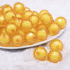 front view of a pile of 20mm Mustard Yellow Translucent Faceted Bead in a bead Bubblegum Bead