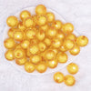 top view of a pile of 20mm Mustard Yellow Translucent Faceted Bead in a bead Bubblegum 