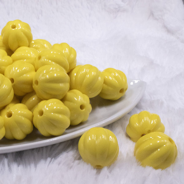 front view of a pile of 20mm Yellow Opaque Pumpkin Shaped Bubblegum Bead