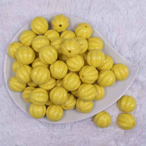 top view of a pile of 20mm Yellow Opaque Pumpkin Shaped Bubblegum Bead