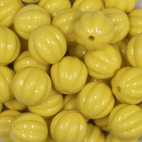 close up view of a pile of 20mm Yellow Opaque Pumpkin Shaped Bubblegum Bead