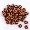top view of a pile of 20mm Orange with Black Stripe Beach Ball Bubblegum Beads