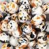 close up view of a pile of 20mm Orange & Black Splatter Chunky Acrylic Bubblegum Beads