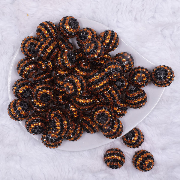 top view of a pile of 20mm Orange and Black Striped Rhinestone Acrylic Bubblegum Beads