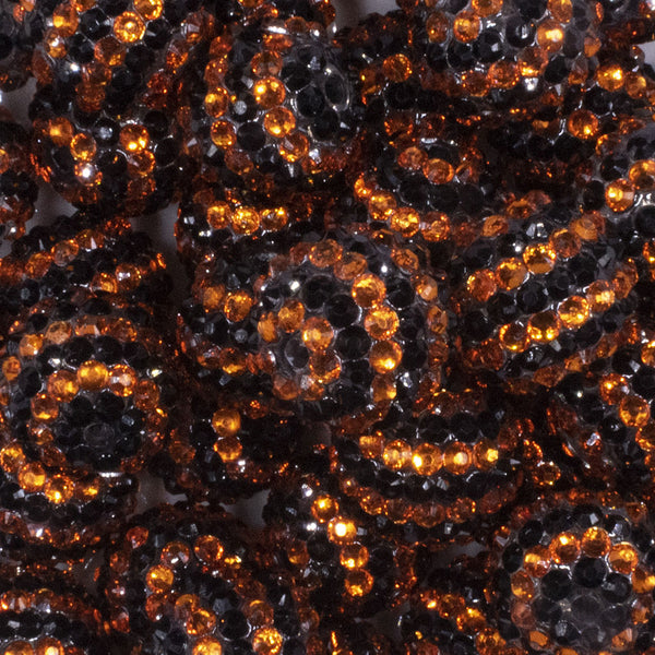 close up view of a pile of 20mm Orange and Black Striped Rhinestone Acrylic Bubblegum Beads