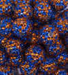 Close up view of a pile of Orange & Blue Confetti Rhinestone AB Bubblegum Beads