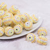 front view of a pile of 20mm Orange and Yellow Striped Rhinestone Bubblegum Beads