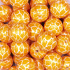 Close up view of a pile of 20mm Orange Leopard Animal Print Acrylic Bubblegum Beads