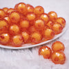 front view of a pile of 20mm Orange Translucent Faceted Bead in a bead Bubblegum Bead